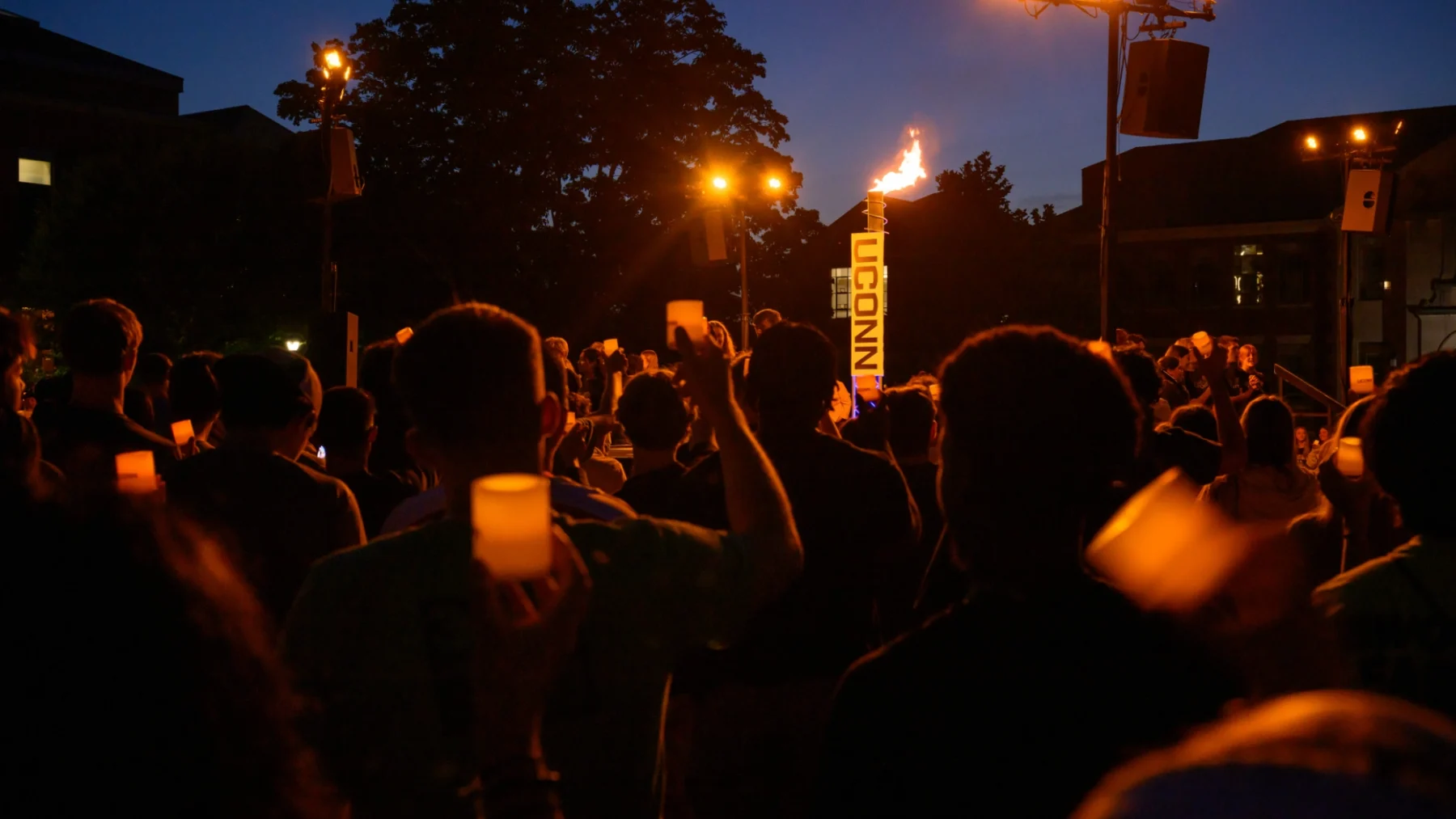 Students gathered at a candlelight event.